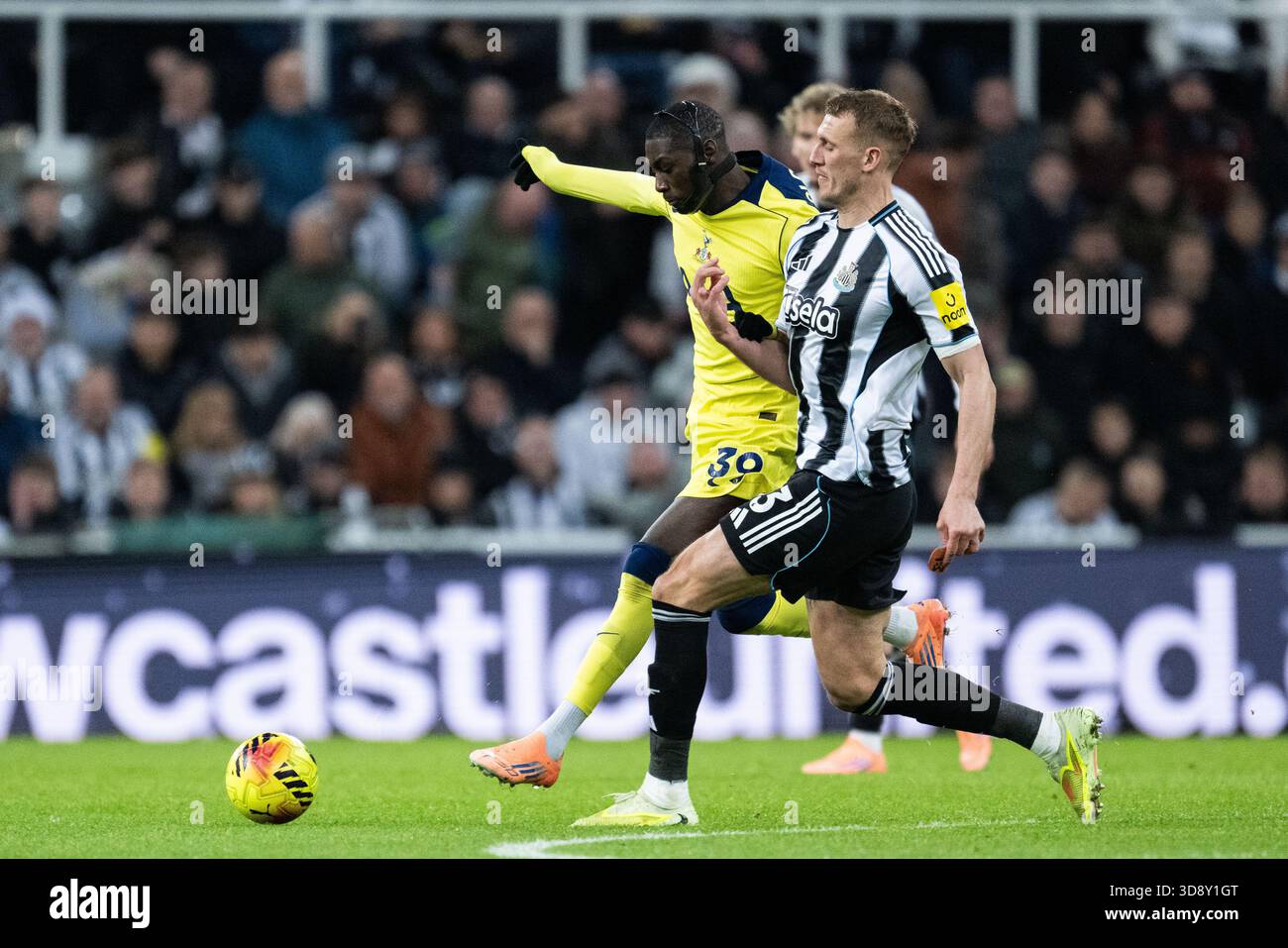Newcastle, UK. 02nd Dec, 2025. NEWCASTLE UPON TYNE, ENGLAND, DEC 2: Dan Burn of Newcastle United (R) and Kolo Muani of Tottenham (L) fight for possession during the Premier League match between Newcastle United and Tottenham Hotspur at St James Park on December 2, 2025 in Newcastle, England. Photo by Will Palmer/SPP Credit: SPP Sport Press Photo. /Alamy Live News Stock Photo