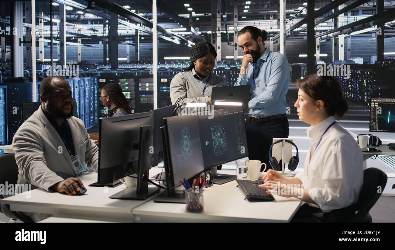 Data center engineers performing maintenance on blade server units used for artificial intelligence processing. IT professionals manage data center arrays used for machine learning training, camera A Stock Photo