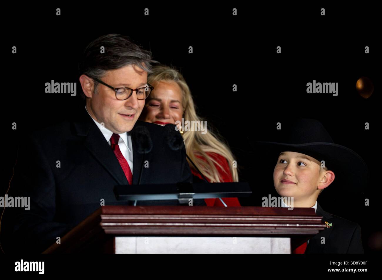Youth Tree Lighter Grady Armstrong looks on as.Speaker of the House Mike Johnson, R-LA, speaks during a ceremony with members of the Nevada Congressional delegation and the Secretary of Agriculture to light the U.S. Capitol Christmas Tree on the West Front Lawn of the U.S. Capitol in Washington, DC on Tuesday, December 2, 2025. The tree, a 53-foot red fir from the Humboldt-Toiyabe National Forest in Nevada, is nicknamed 'Silver Belle' and is the first Capitol Christmas Tree to be selected from Nevada. Photo by Bonnie Cash/UPI Stock Photo