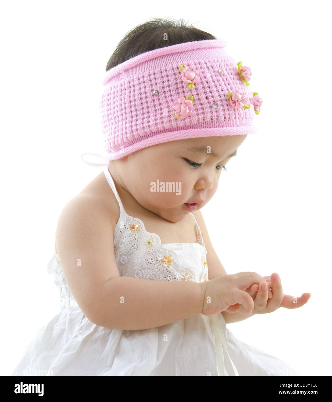 Asian baby girl playing with her hand Stock Photo