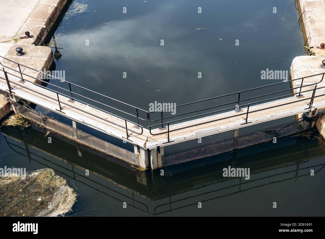 Canal Railing Close-up view of a Rideau Canal lock gate with wooden walkway, metal ...