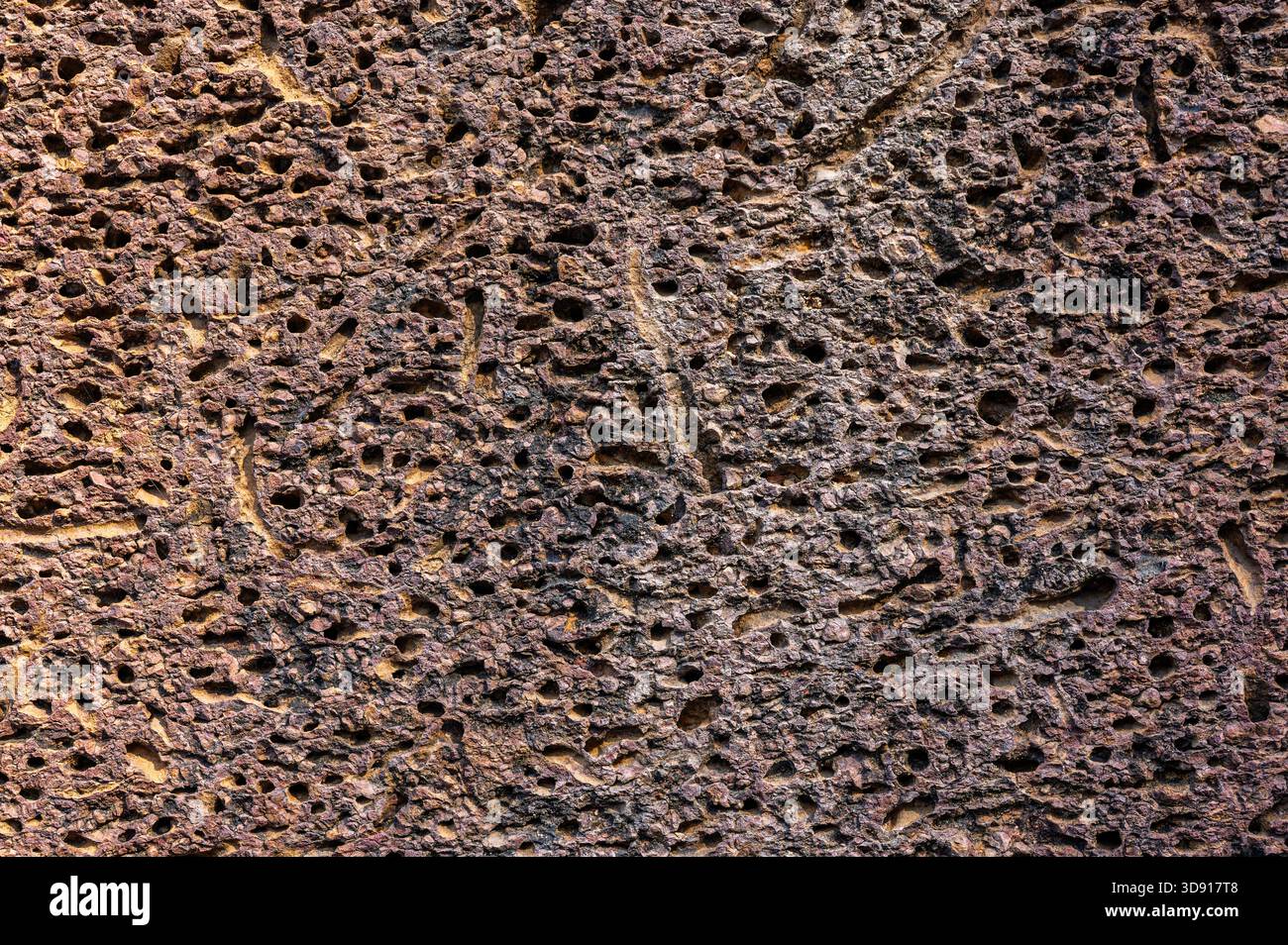 Texture Abstract background of brown pitted rock surface showing ...