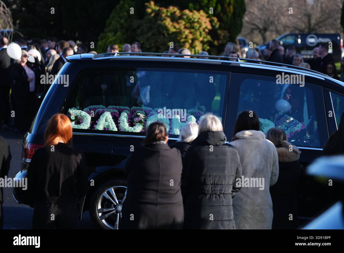 The hearse arriving with floral tributes for the funeral of Chloe Hipson at Daldowie Crematorium in Glasgow. 21-year-old Chloe was one of five people killed when their Volkswagen Golf was in a collision with a Toyota Land Cruiser on a road near Dundalk on November 15. Picture date: Tuesday December 2, 2025. Stock Photo