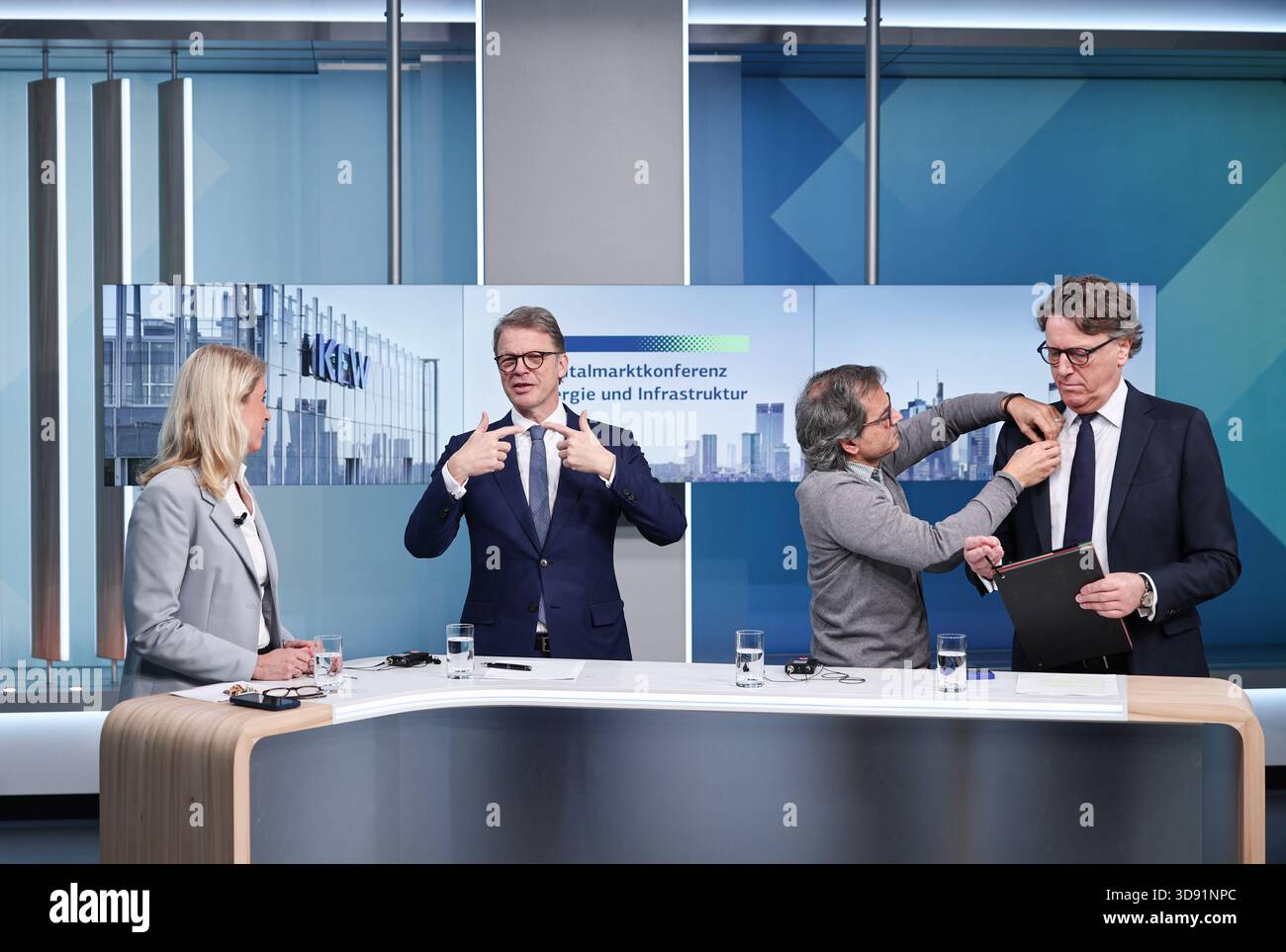 03 December 2025, Hesse, Frankfurt/Main: Christian Sewing (2nd from left), CEO of Deutsche Bank, and Stefan Wintels (r), CEO of KfW, are being prepared for their appearance at the 'Energy and Infrastructure' capital market conference. Photo: Hannes P. Albert/dpa Stock Photo