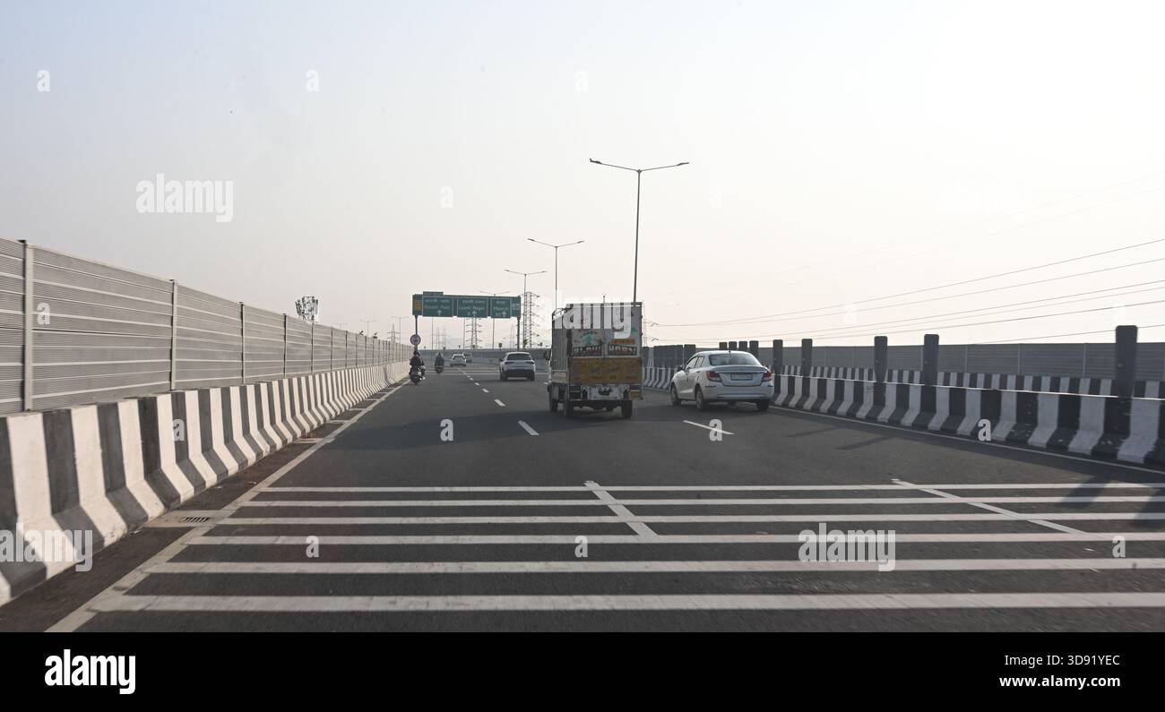 NEW DELHI, INDIA - DECEMBER 1: Traffic seen on Saharanpur Dehradun Expressway as it is open for Public Trial from last night, on December 1, 2025 in New Delhi, India. Once completed, the 210 km high-speed corridor is expected to reduce the travel time between Delhi and Dehradun from the current 6 to 6.5 hours to just 2 to 2.5 hours, significantly improving connectivity between the national capital, western Uttar Pradesh, and Uttarakhand. Authorities are preparing to inaugurate a 32 km-long completed section of the expressway between late December and early January, even as work continues at an Stock Photo