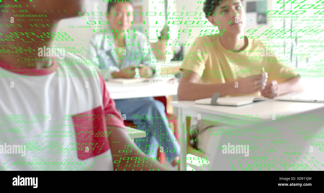 Writing student in yellow tee taking notes with pen in classroom, green code overlay, copy space Stock Photo