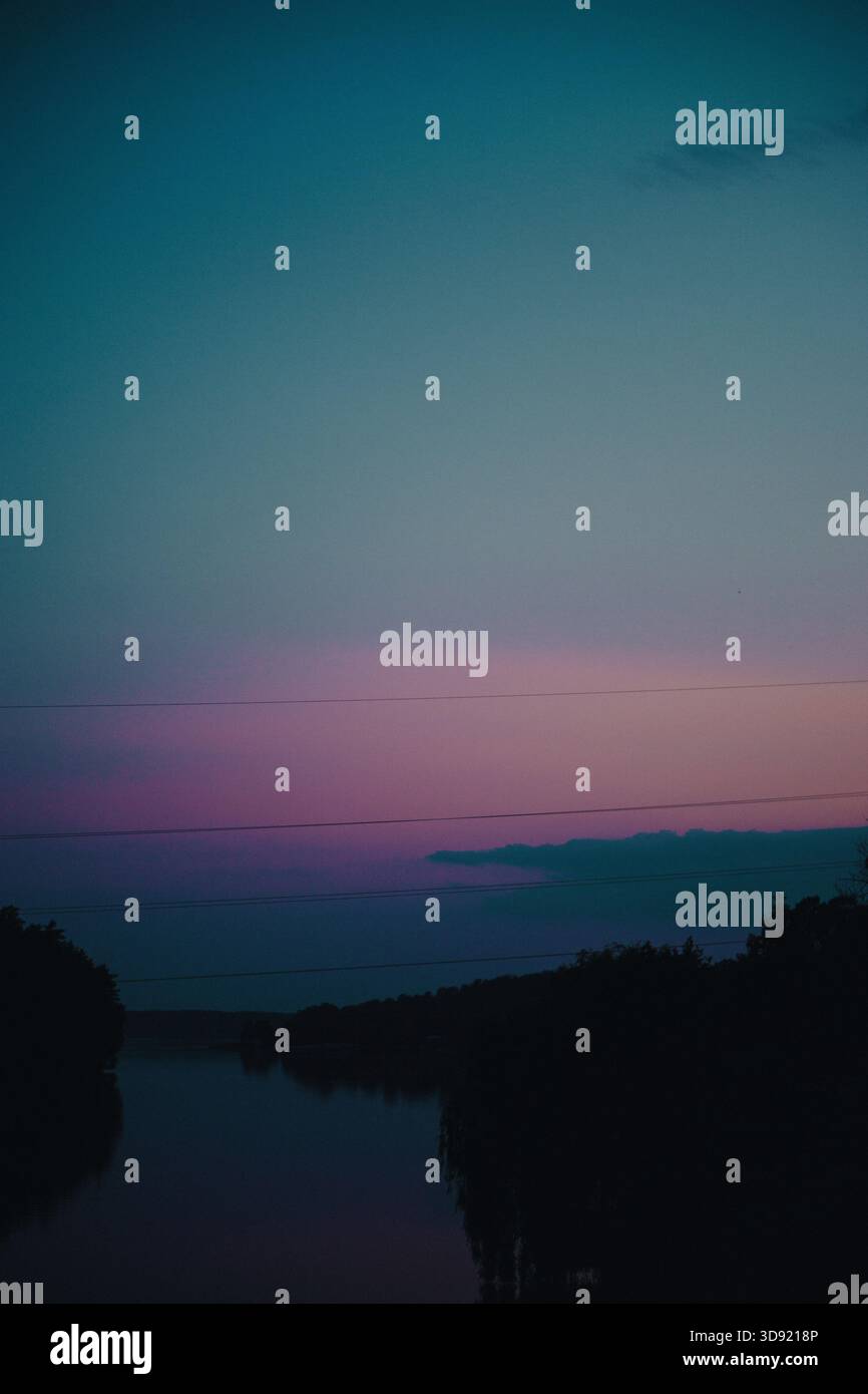 Beautiful gradient sunset by the river and forest Stock Photo