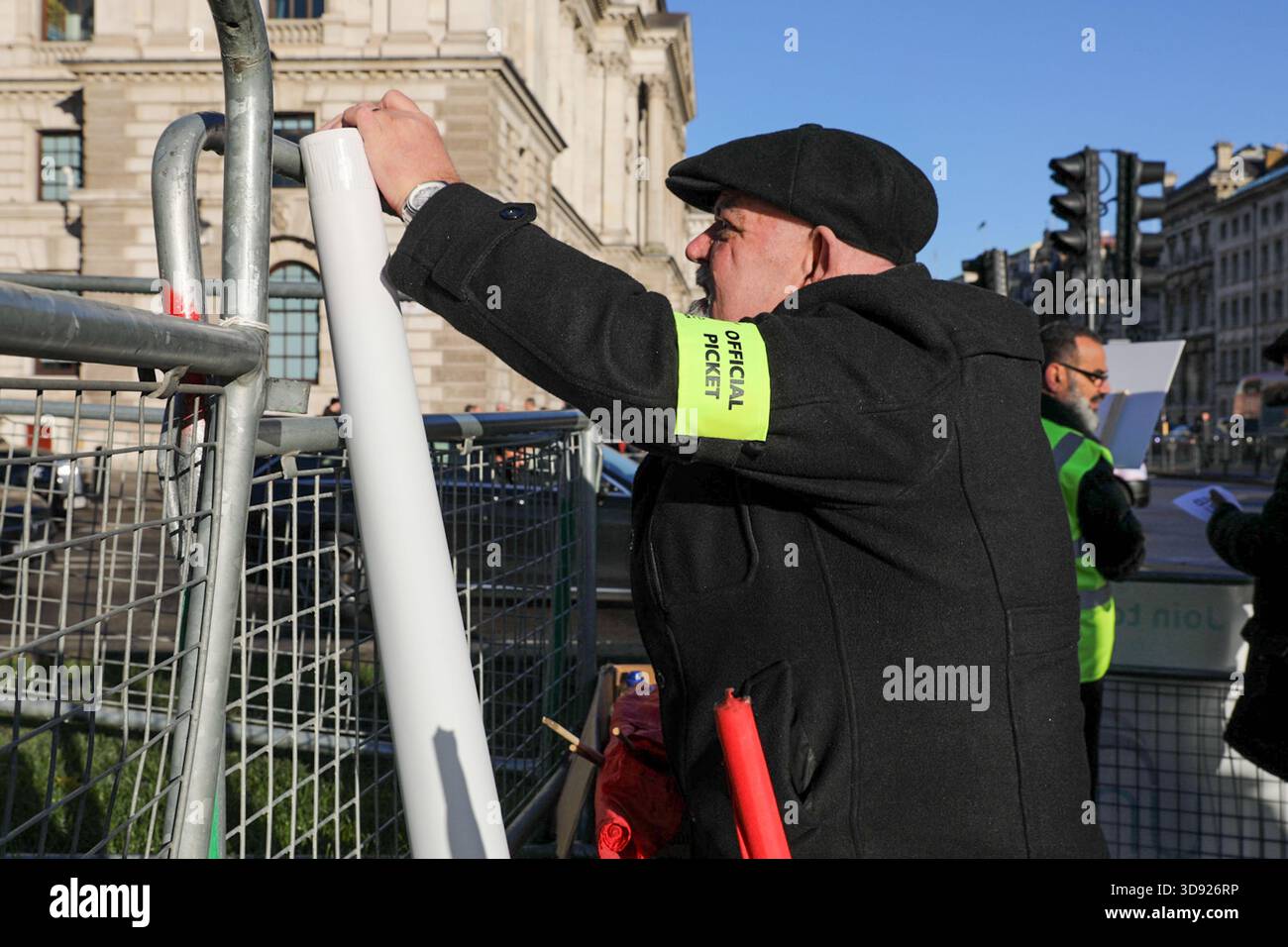 London, UK, 3rd November 2025. A Unite Union member hangs a banner during a demonstration.Taxi and private hire drivers protested in Westminster, calling for action on the Casey report's call to end out-of-area licensing. The demonstration, organised by the Unite union, brought together drivers from across the UK who are concerned about regulations, safety, and driver incomes. The key issue is licence shopping—current laws allow drivers to get licensed by any local authority, no matter where they intend to work. Credit:James Willoughby/ALAMY Live News Stock Photo