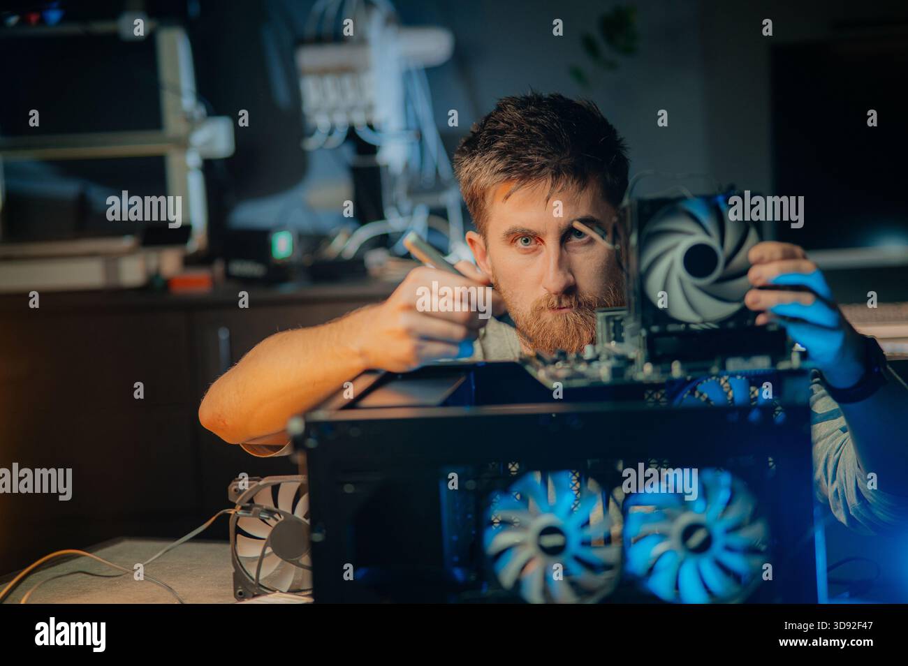 Man assembles a computer system unit at home Stock Photo