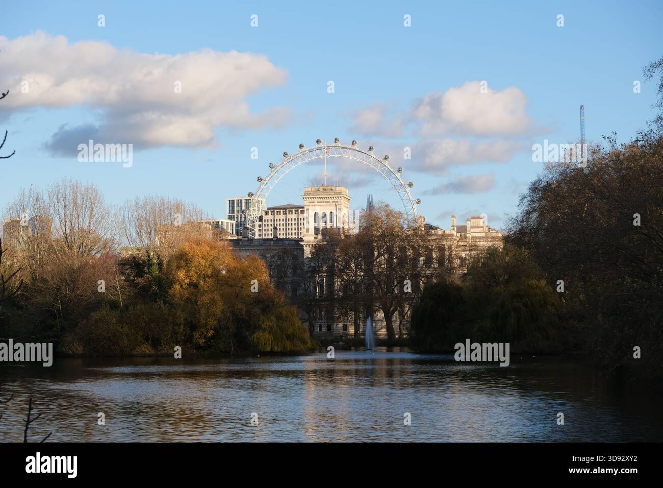 The London Eye and Whitehall as seen across the lake in St James's Park on a late autumn day Stock Photo