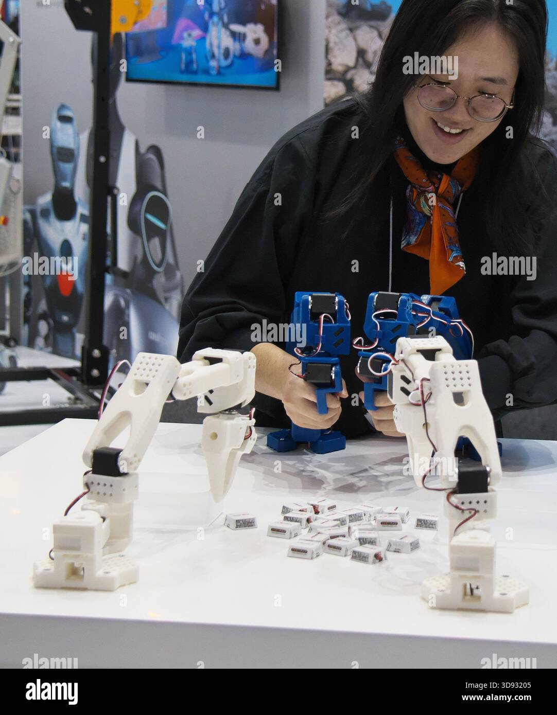Visitor try out the remote control the robot arm during the ...
