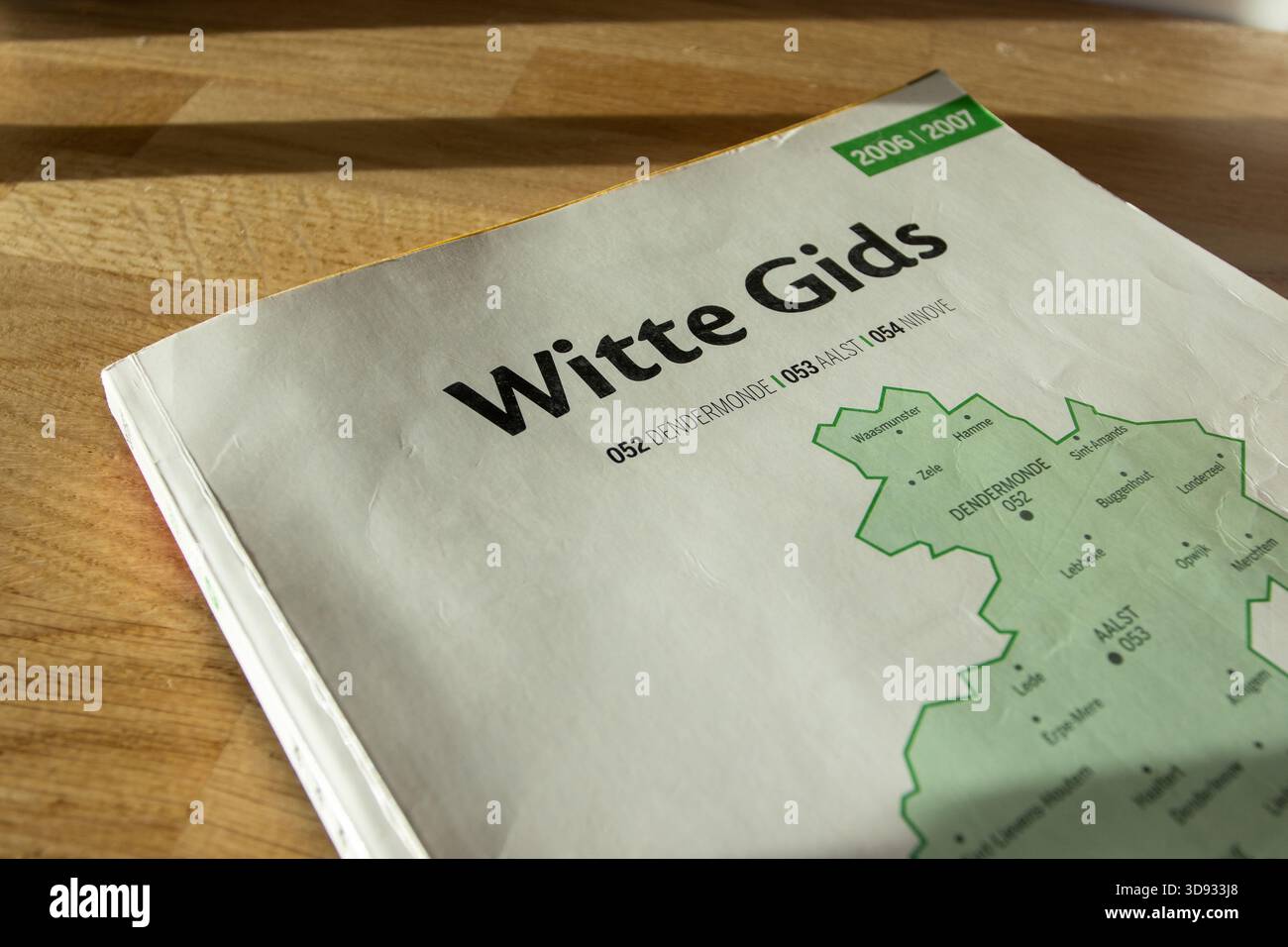 AALST, BELGIUM, 2 DECEMBER 2025: Illustrative editorial image of an obsolete paper phonebook the 'Witte Gids', White Pages telephone directory of Flan - Stock Image