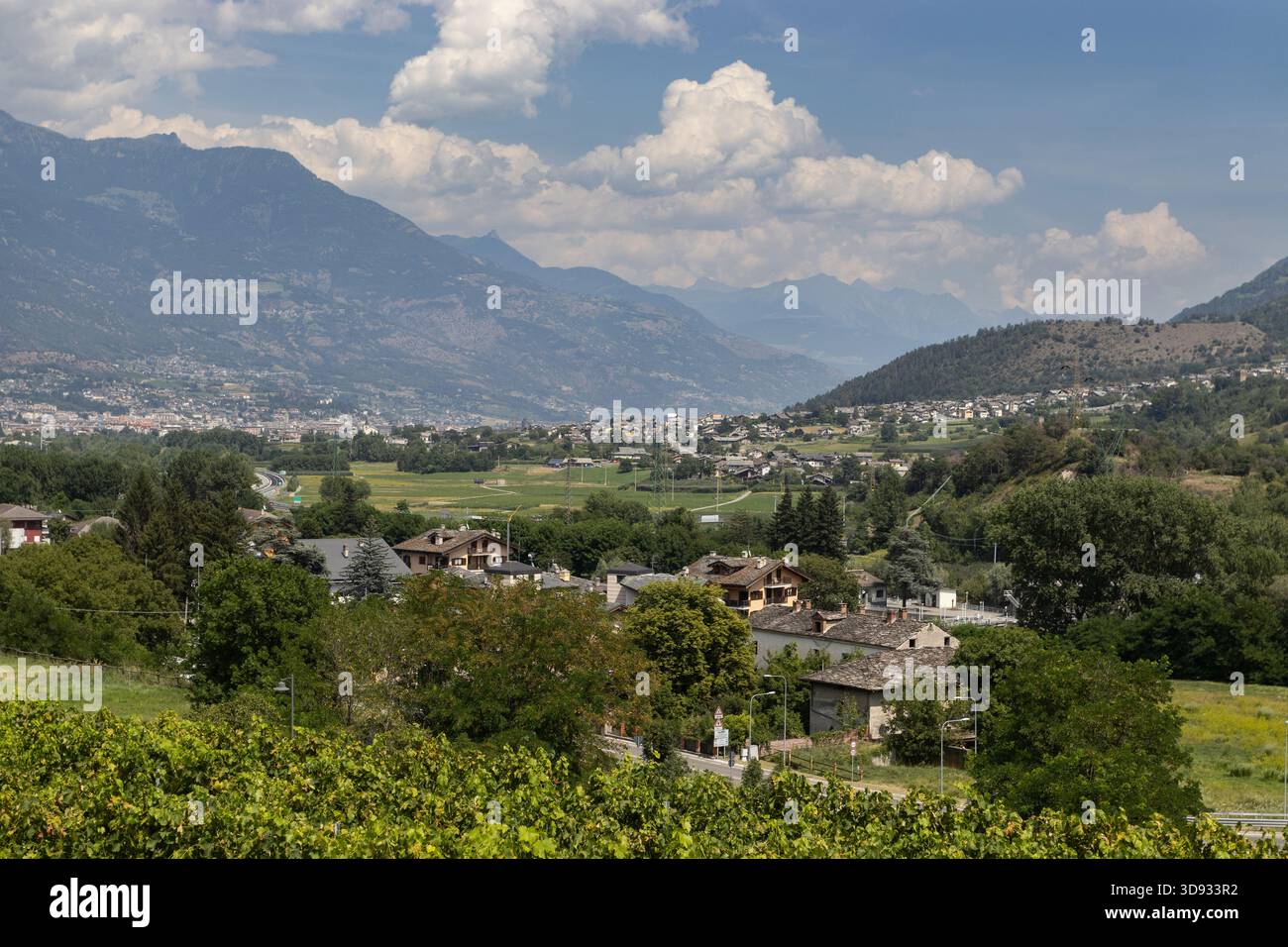 View of the beautiful Aosta Valley above the town of Sarre, in Northern Italy, looking towards, Aosta town on a warm summers day. Copy space above. - Stock Image