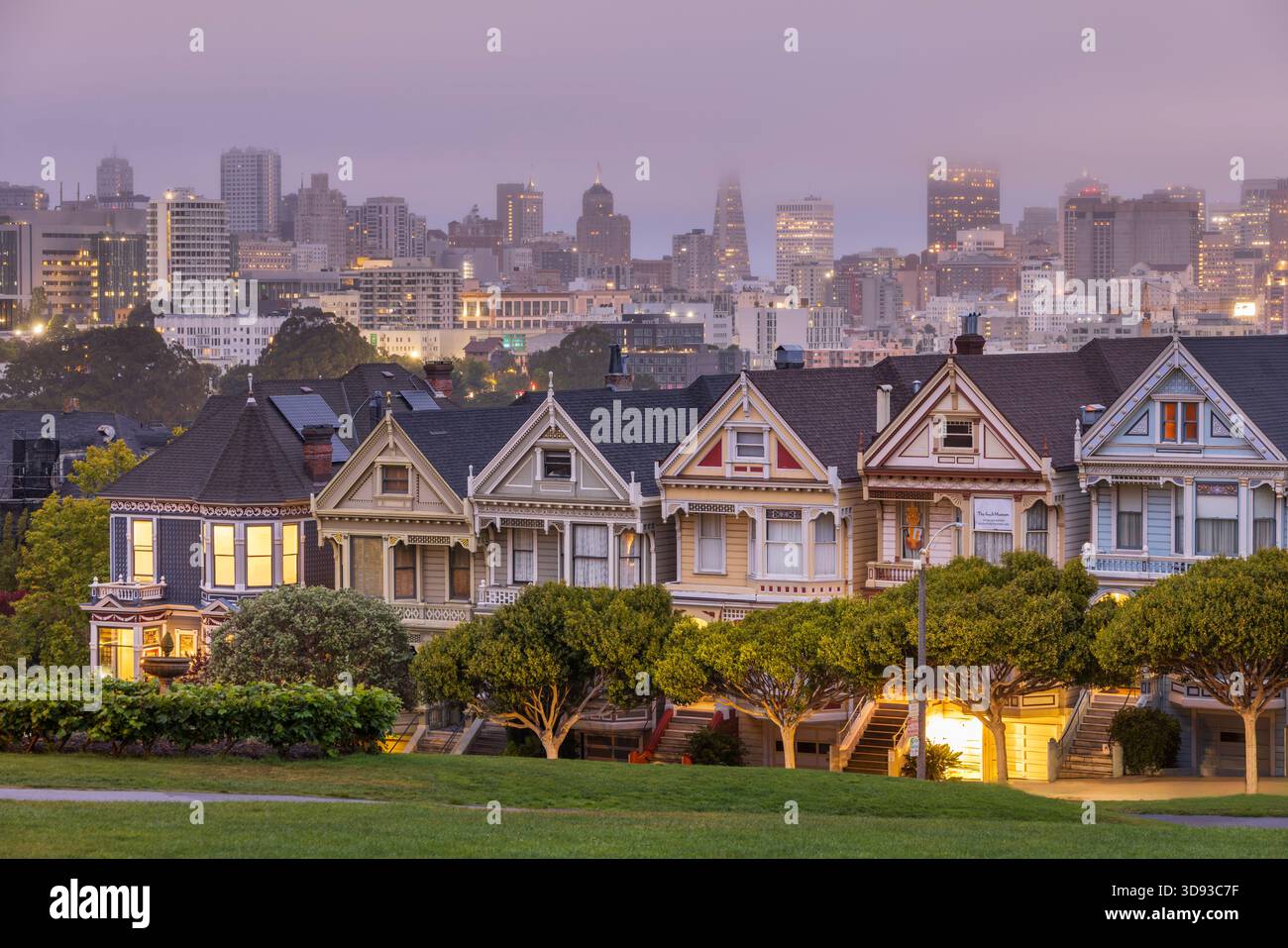 The Painted Ladies houses near Alamo Square at dawn, with the City of San Francisco emerging from morning fog, California, USA.  Summer (August) 2025. Stock Photo