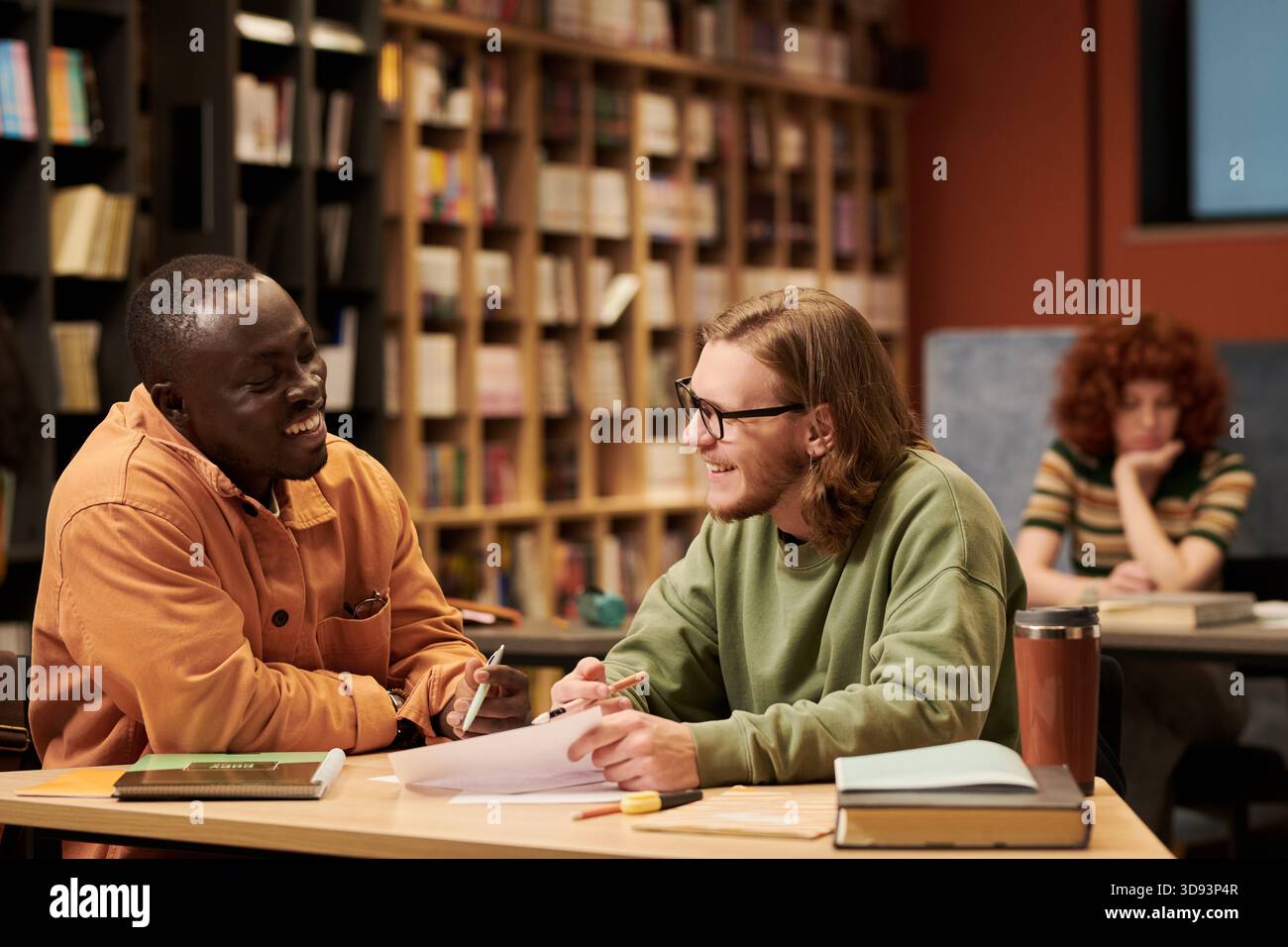 Young Black Man and Man Studying Together in Library Stock Photo