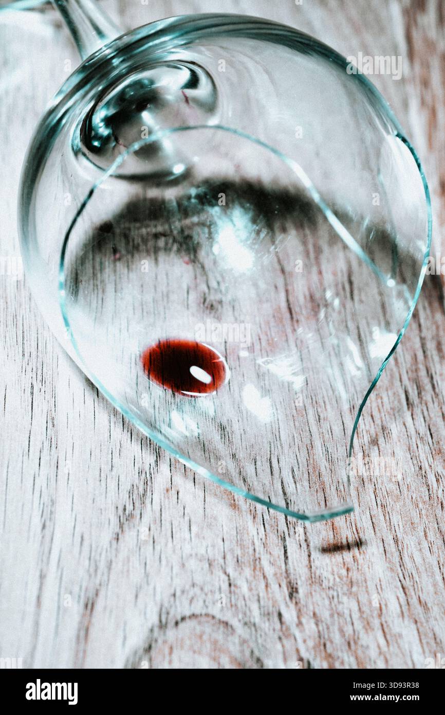 Red wine in a broken wine glass Stock Photo