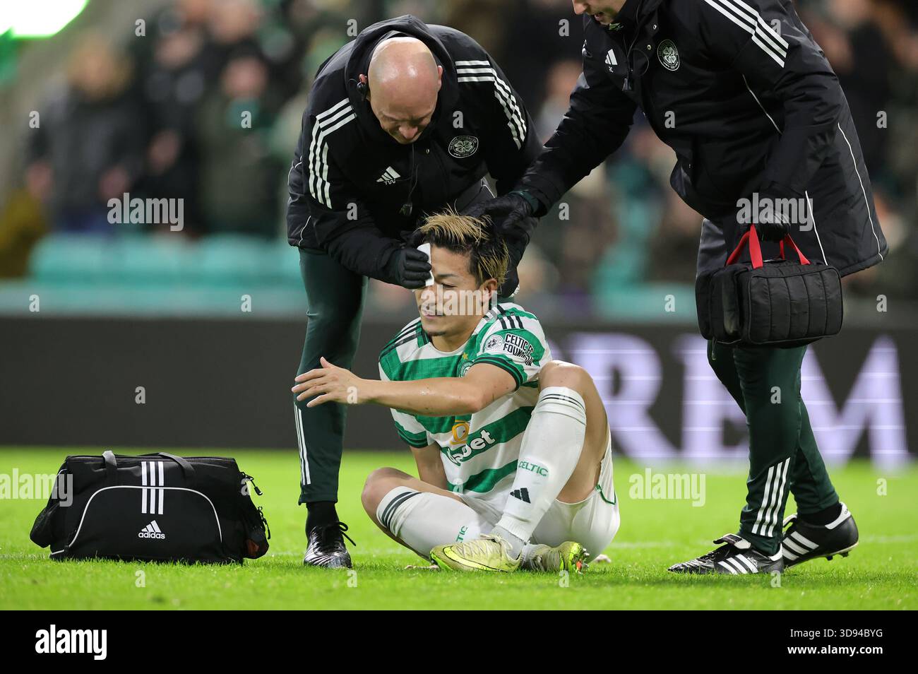 Celtic's Daizen Maeda receives treatment for a head injury after ...
