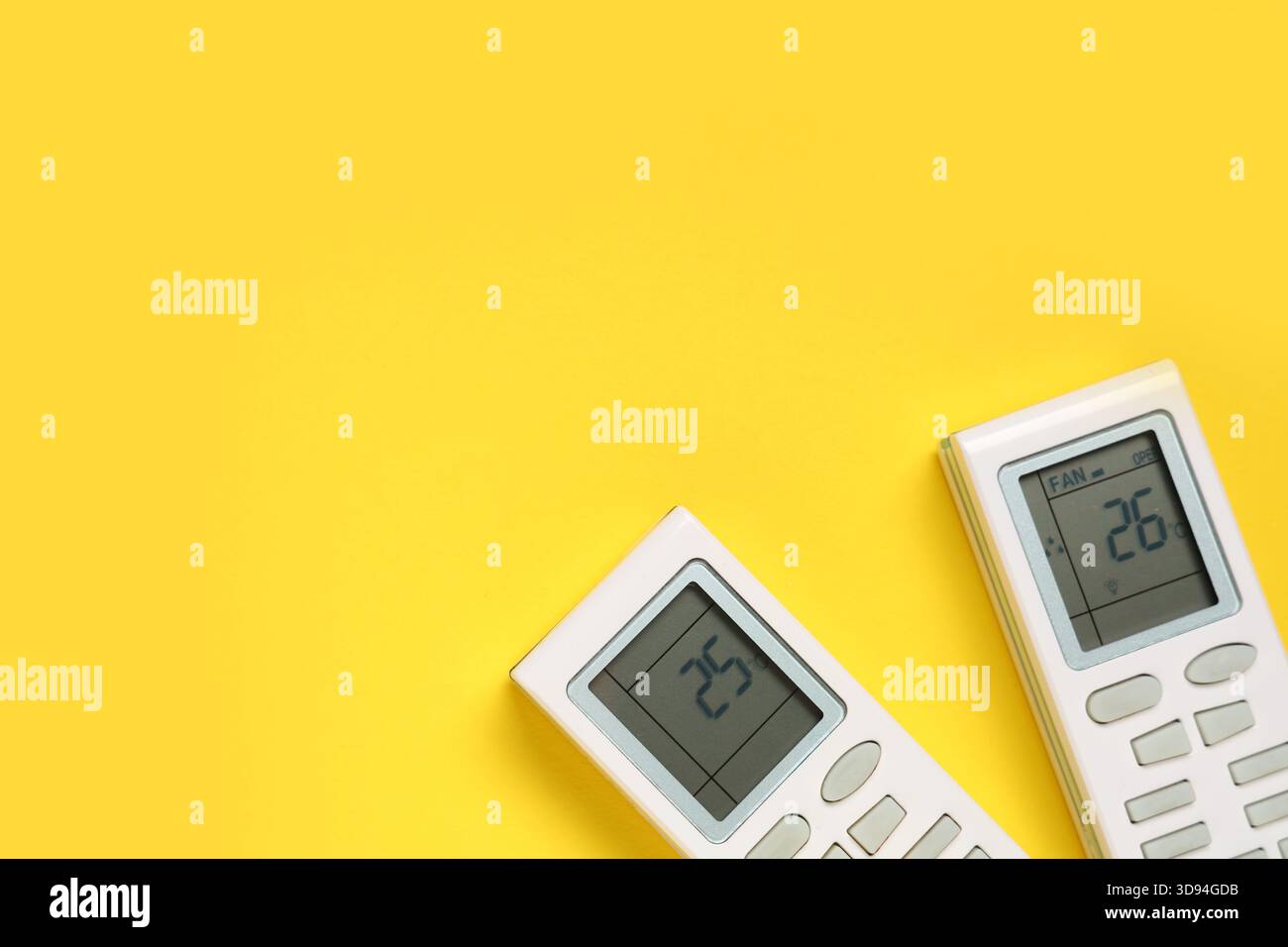 Air conditioner remote controls on yellow background Stock Photo