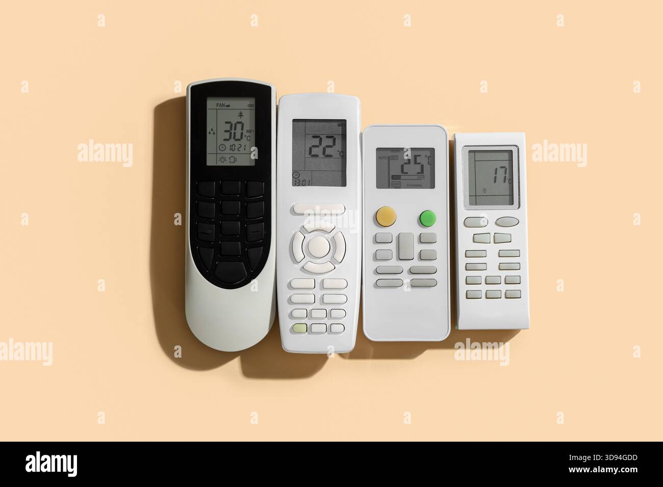 Air conditioner remote controls on beige background Stock Photo
