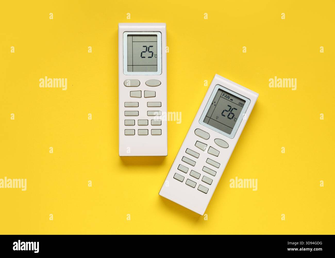 Air conditioner remote controls on yellow background Stock Photo