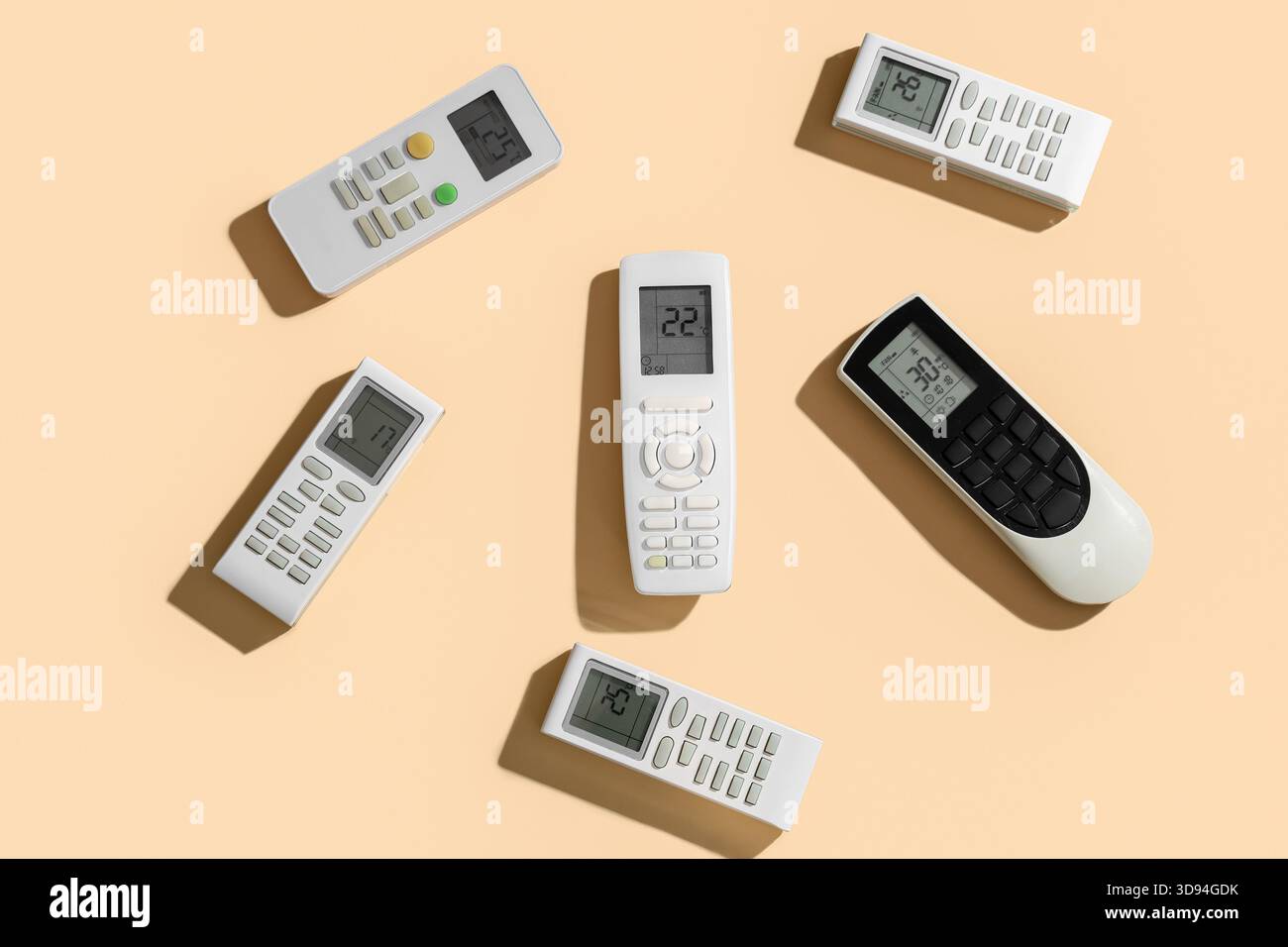 Air conditioner remote controls on beige background Stock Photo