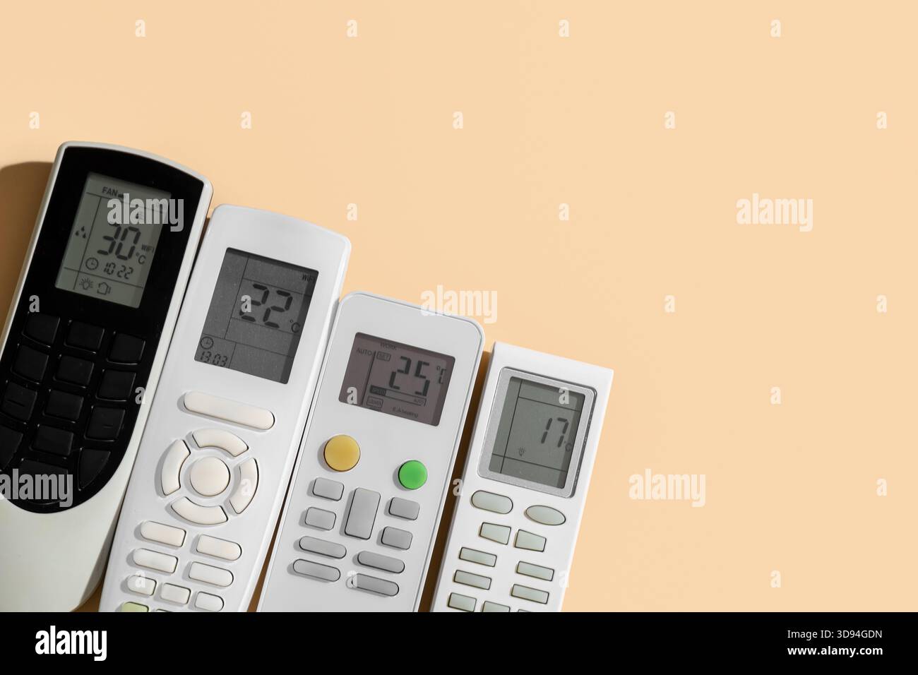 Air conditioner remote controls on beige background Stock Photo