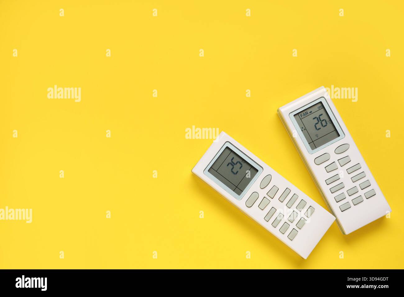 Air conditioner remote controls on yellow background Stock Photo