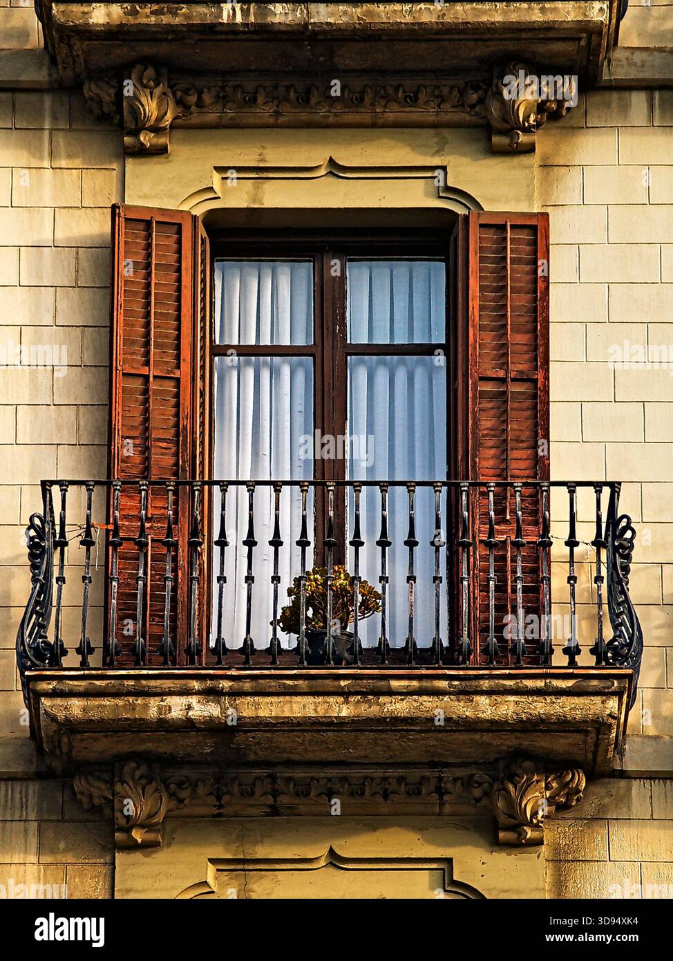 Charming and picturesque window with louvered shutters and iron balcony ...