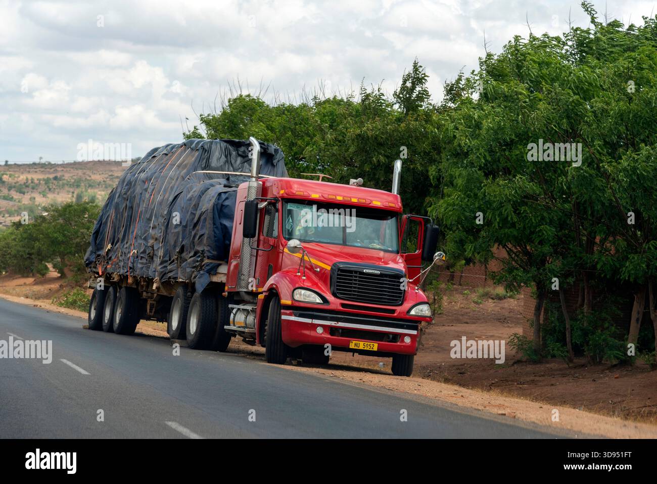 Malawi Africa. 13.11.2025.  Broken down truck on roadside with blocks by the wheels to prevent the truck moving backwards, - Stock Image