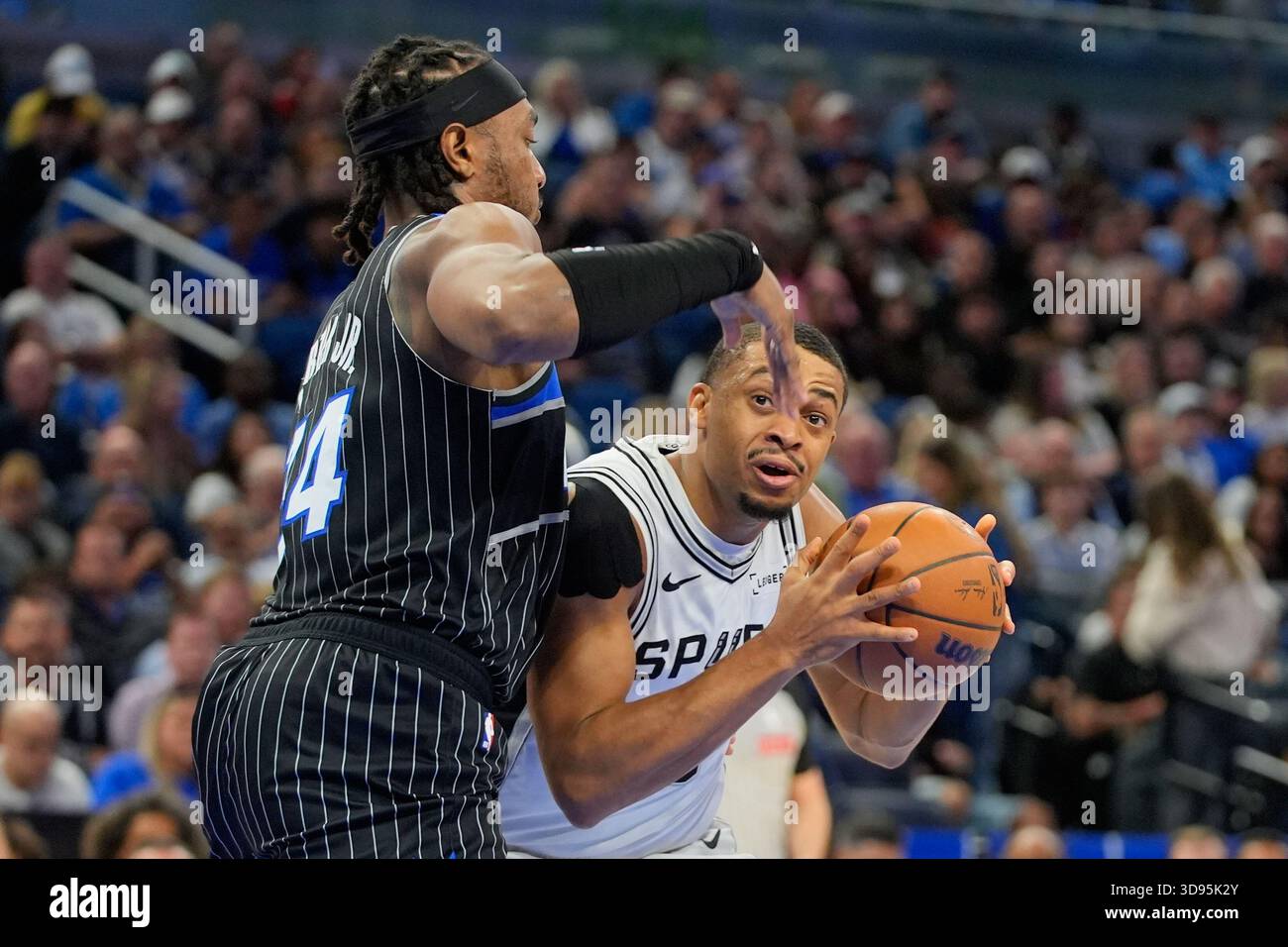 San Antonio Spurs forward Keldon Johnson, right, look for a shot as ...