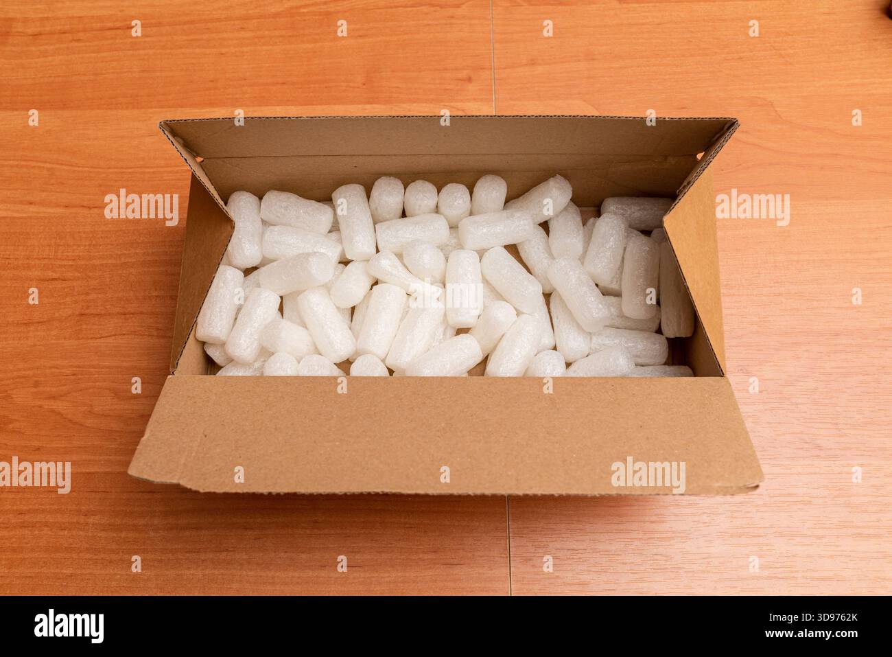 Shipping cardboard box with foam cubes, gift package. Top view. Stock Photo