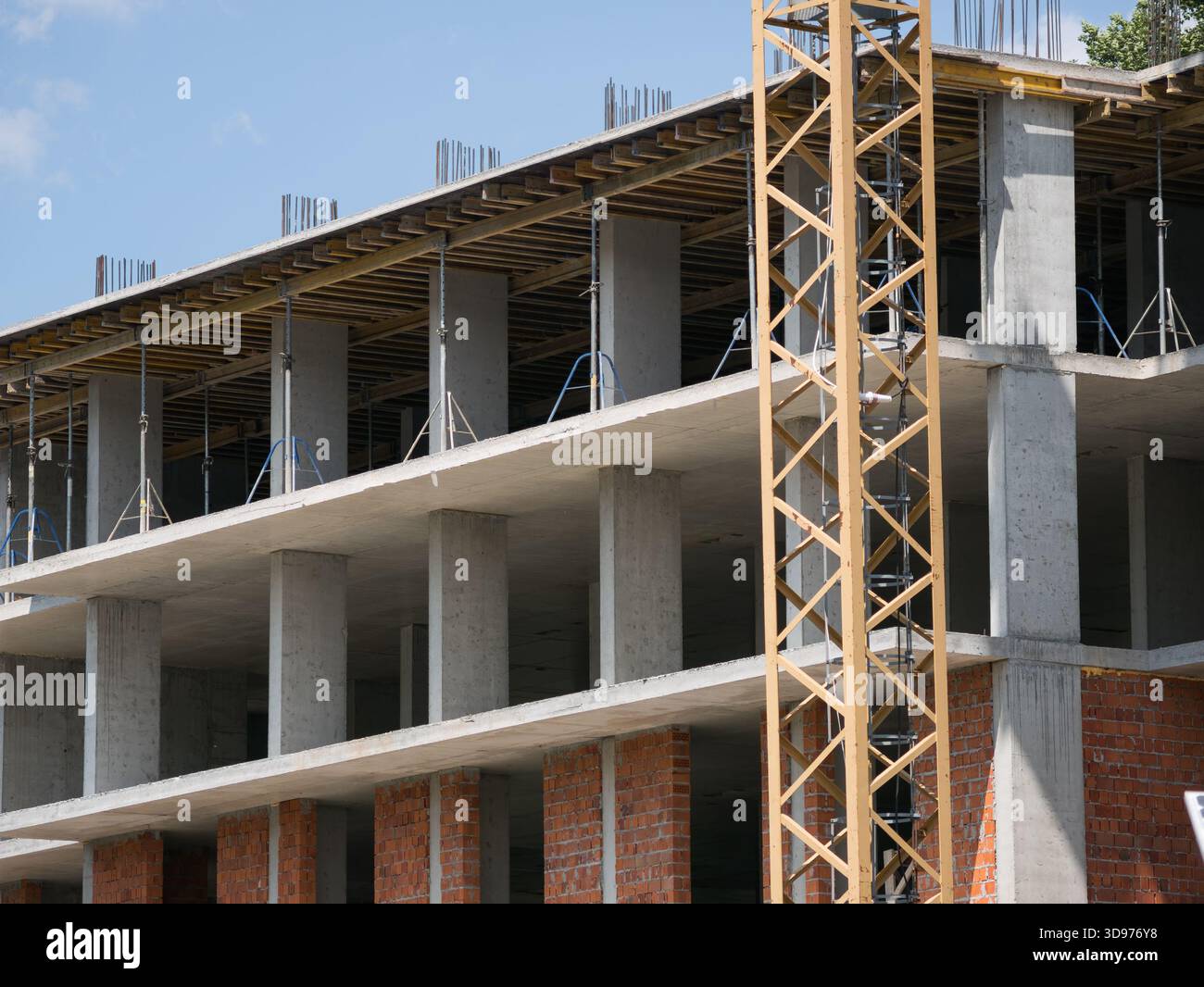 Detailed view of a monolithic-frame building being built, featuring ...