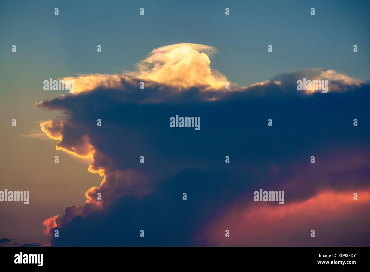 Dramatic vibrant clouds formation on blue sky in the sunset Stock Photo