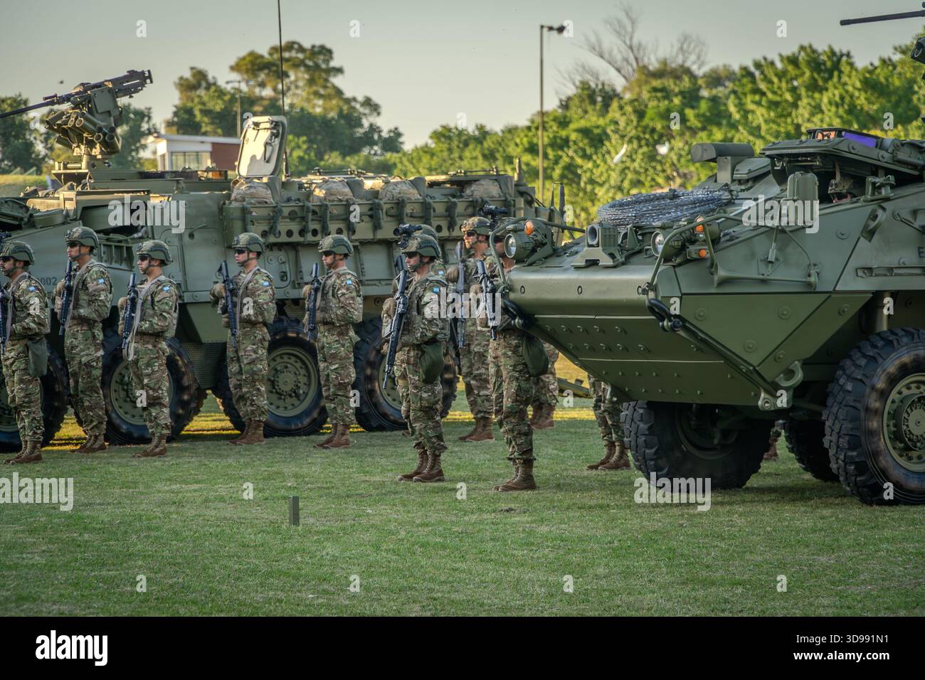 Stryker combat vehicles alongside soldiers pose during the presentation ...