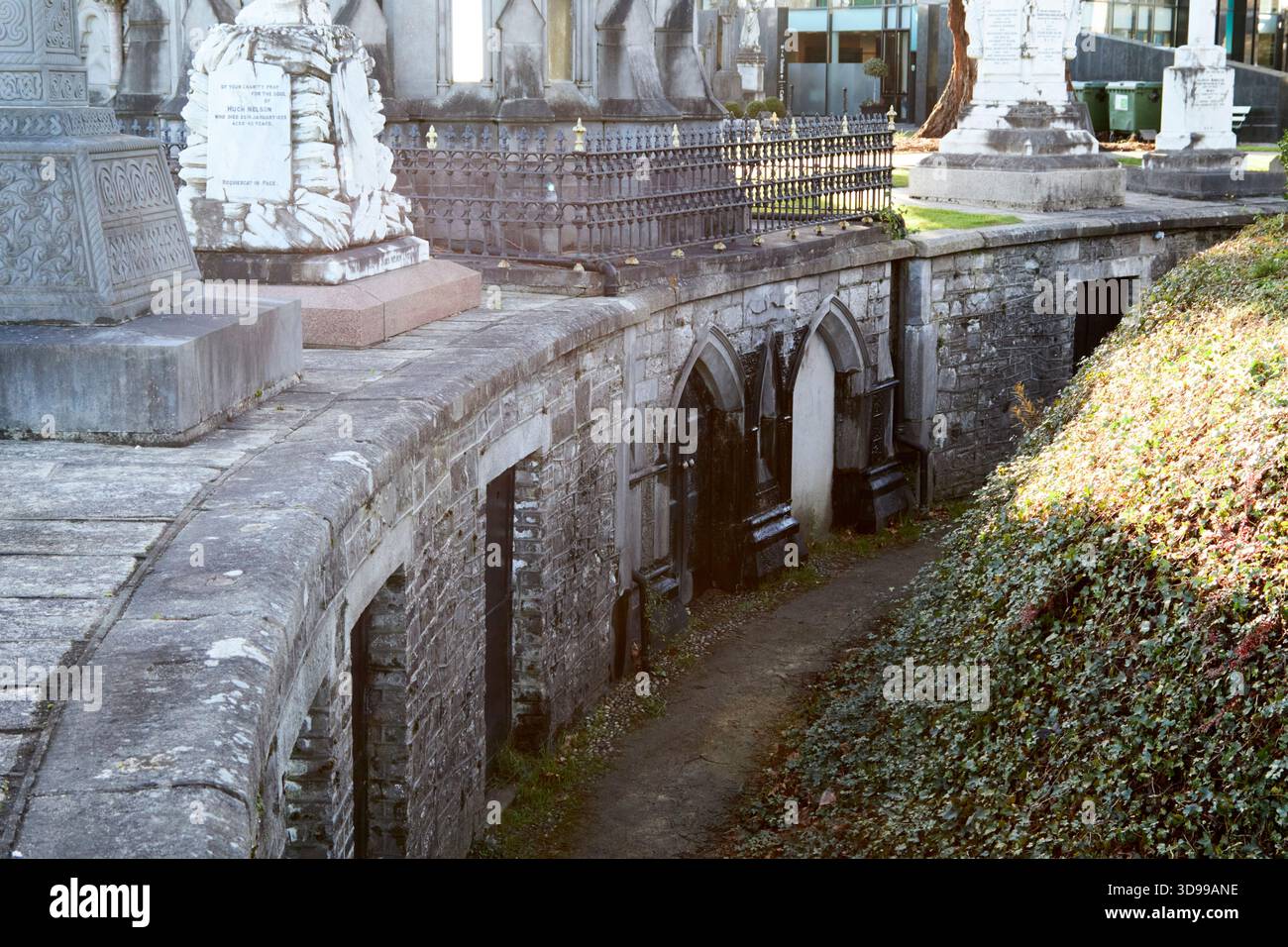 tomb entrances beneath monuments glasnevin cemetery dublin, republic of ireland the gothic vault entrances are to the boland mausoleum Stock Photo