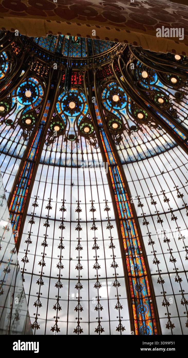Ornate stained glass dome ceiling with radial floral patterns and vibrant colors in historic architecture. - Smartphone Captured Stock Image