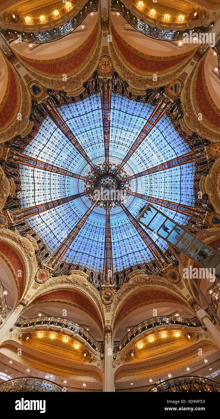 Interior view of ornate dome ceiling with radial glass panels and balconies in historic building. - Smartphone Captured Stock Image