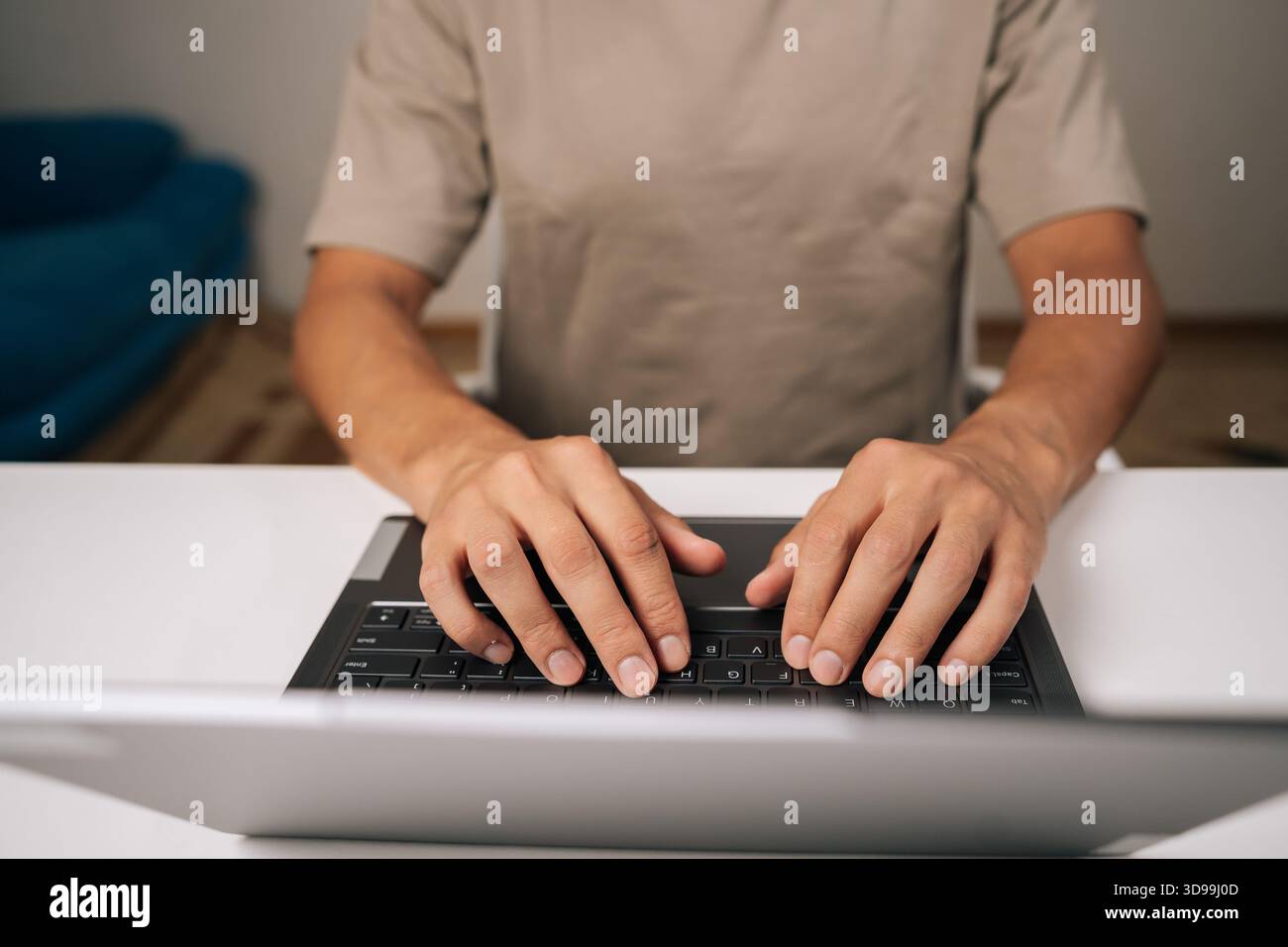 Close-up top view of programmer male hands typing code on laptop keyboard, showcasing process of software development and coding expertise. Stock Photo