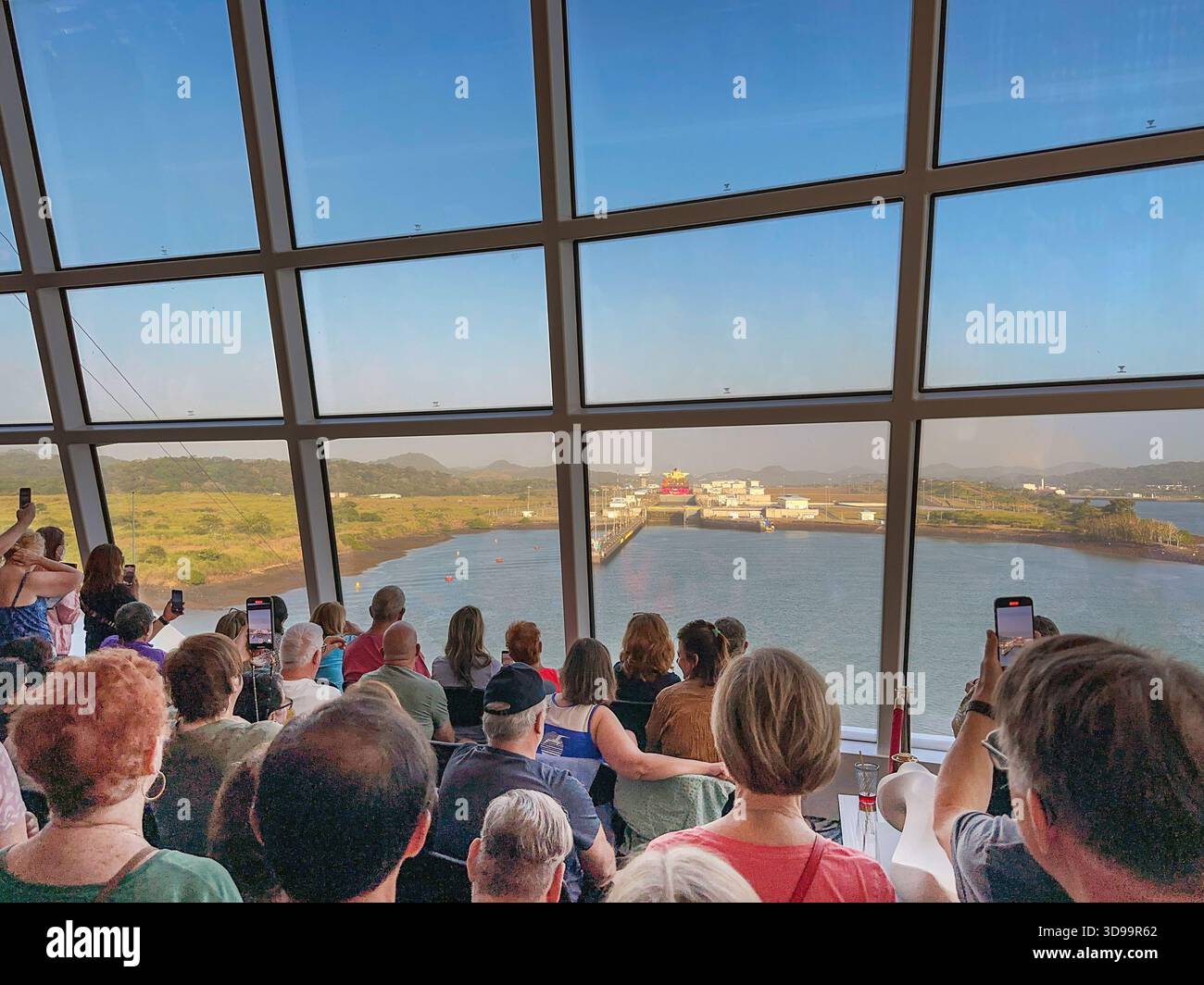 Panama Canal, Panama - 23 January 2024: People in the front lounge of a cruise ship approaching the Cocoli set of locks on the Panama Canal - Smartphone Captured Stock Image