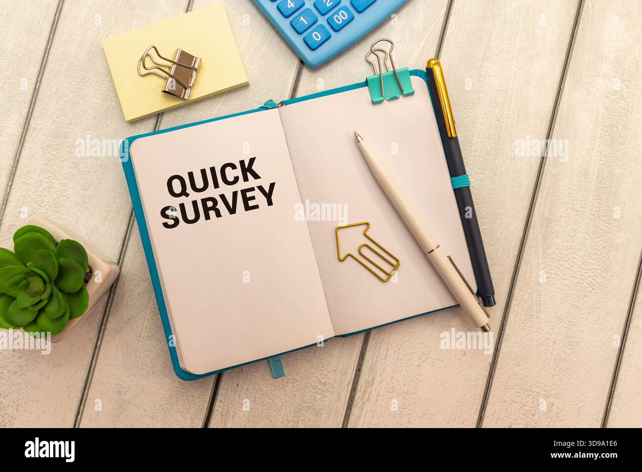 Quick Survey text written on notepad with alarm clock on blue background Stock Photo