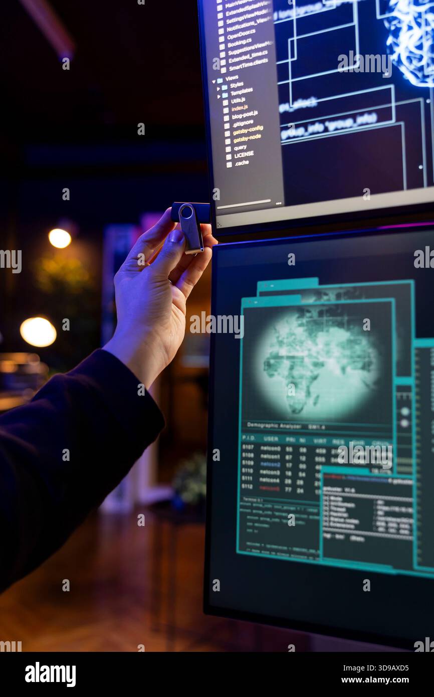 Rogue software developer penetrating firewalls using data theft script on USB stick. Close up of hacker doing covert operations, bypassing security using phishing software on thumb drive Stock Photo