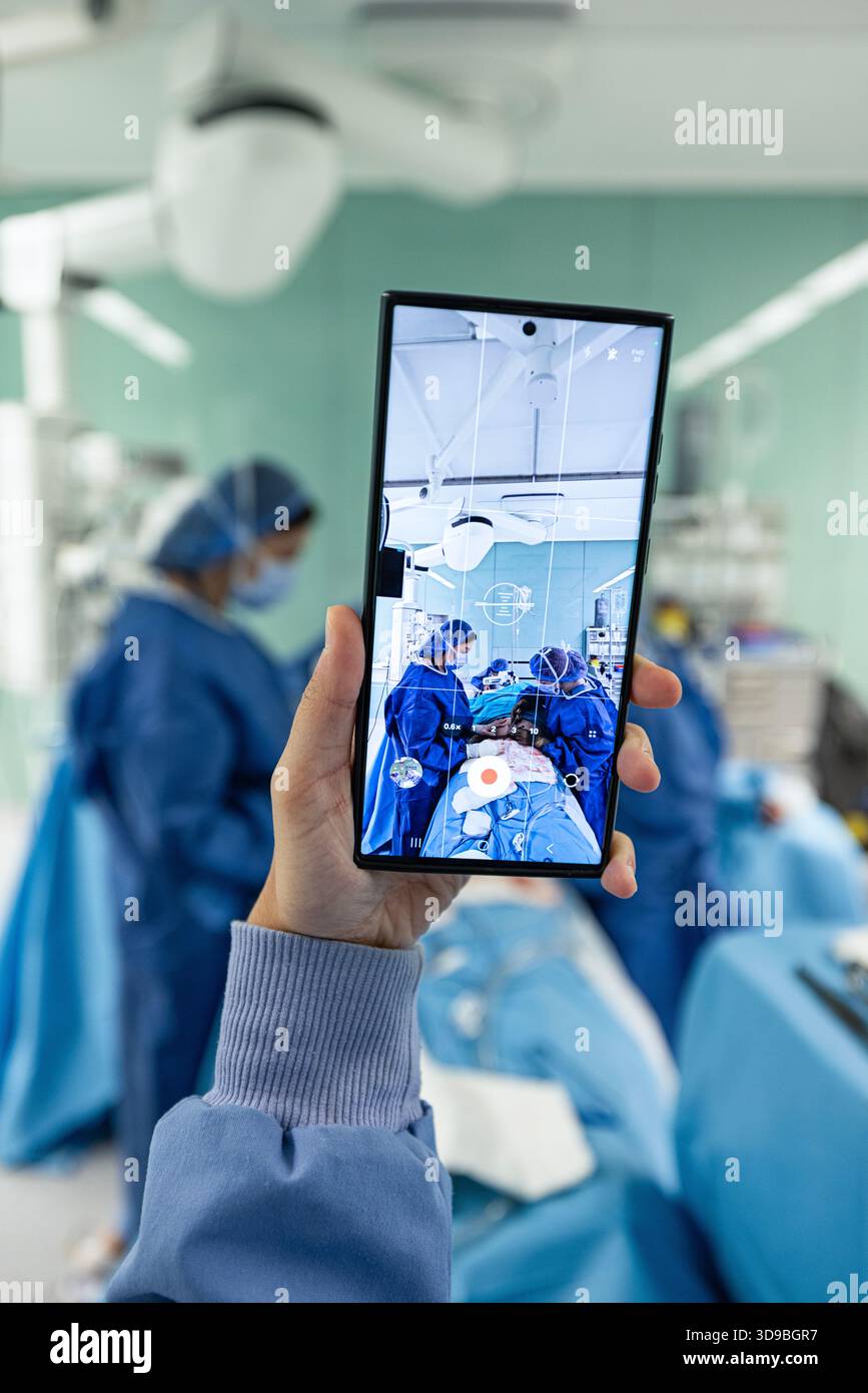 Doctor uses mobile phone during hi-res stock photography and images - Alamy