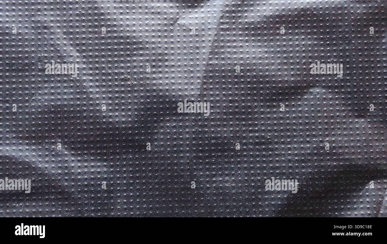 Abstract Crumpled Black Plastic or Fabric Texture with Repeating Grid Dot Pattern and Dramatic Shadow Details Stock Photo