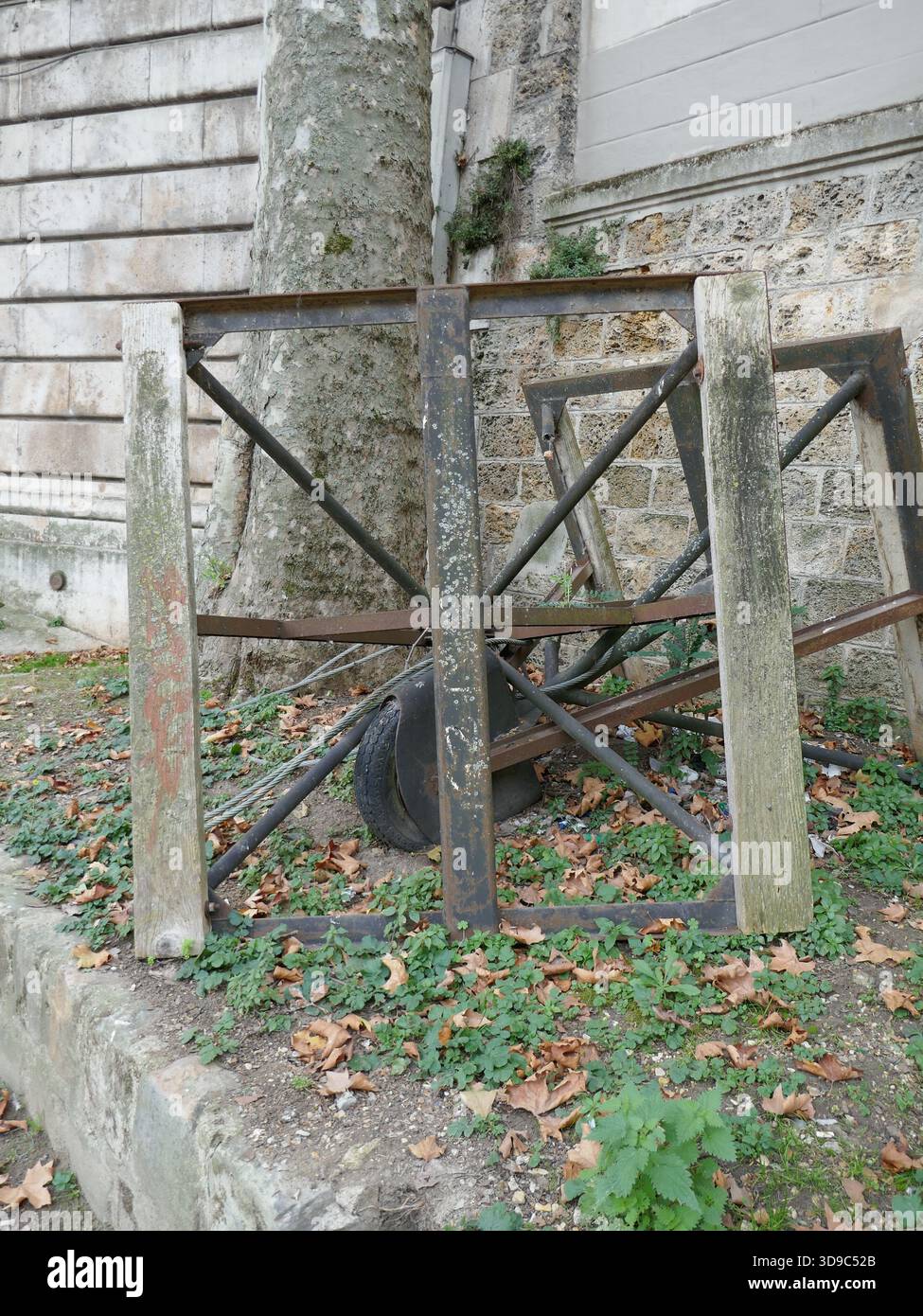 Abandoned work site equipment with old wheel and frames vertical photo Stock Photo