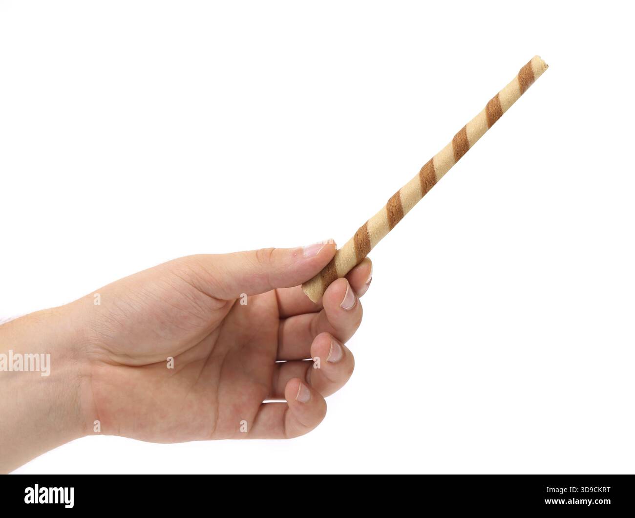 Hand holds striped wafer rolls filled with chocolate isolated on white Stock Photo