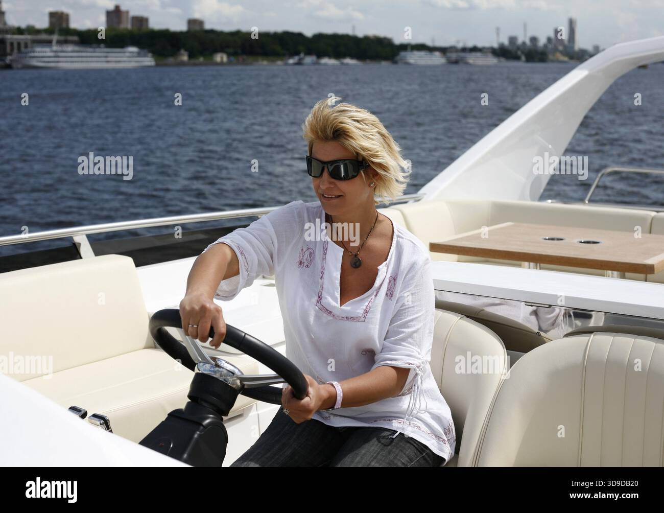 Woman behind wheel of boat hi-res stock photography and images - Alamy