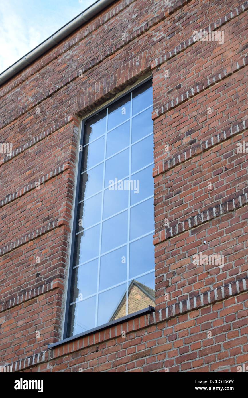 modern window in an old red brick building Stock Photo