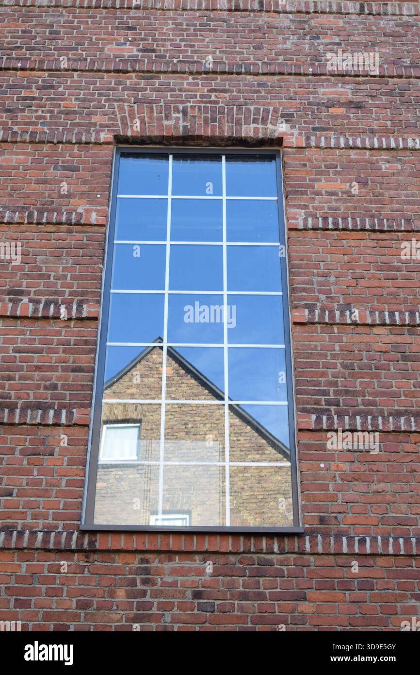 modern window in an old red brick building Stock Photo