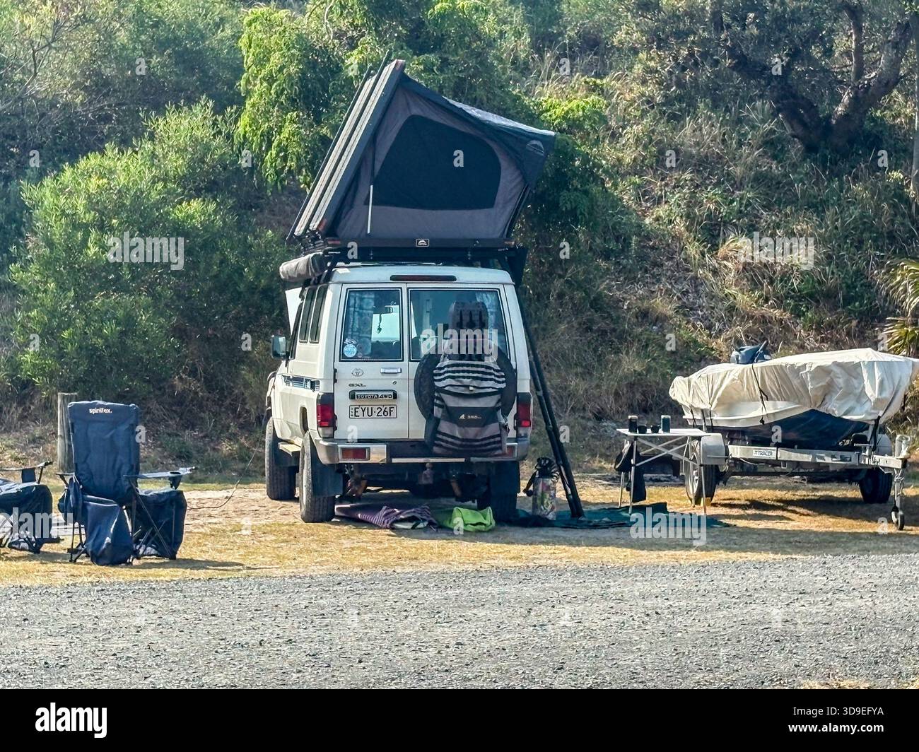 Toyota Landcruiser troop carrier vehicle with rooftop tent camping in Myall Lakes National park in Banksia Green campground,NSW,Australia - Smartphone Captured Stock Image
