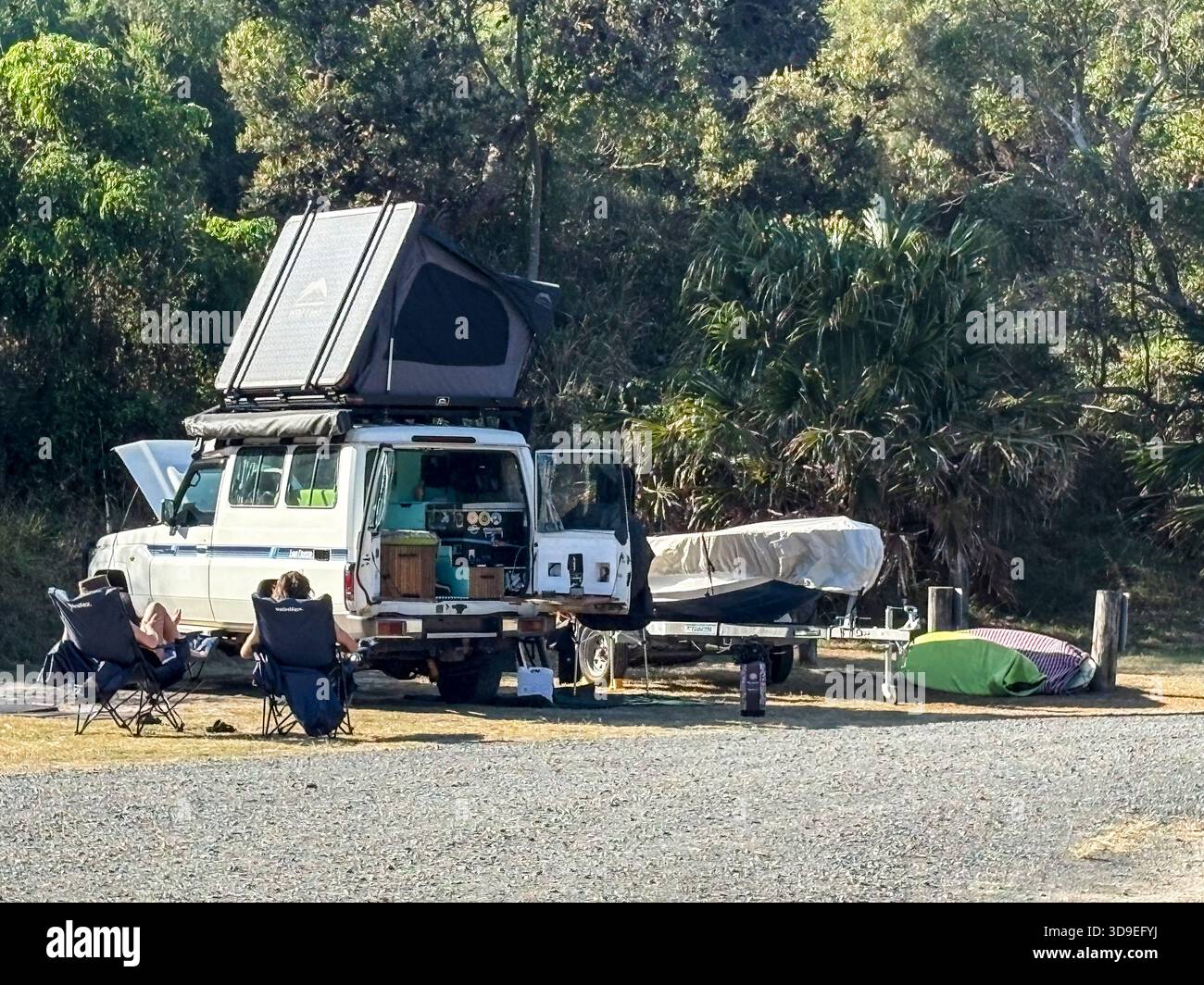 Australia, young couple camping in Myall Lakes national park with off road 4WD Toyota Landcruiser vehicle and rooftop tent installed - Smartphone Captured Stock Image